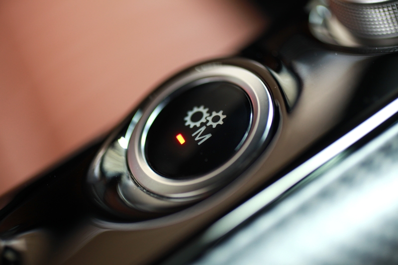 This particular button makes you shift the gears manually via the steering mounted paddle-shifters - perfect for track days