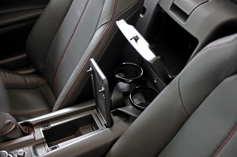 The interior hides some useful storage compartments, along with a pair of bottle holders