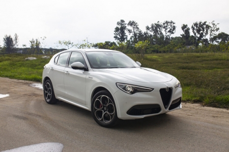 For a rather rounded-edge SUV, those downward-sloping headlights and signature pointy Alfa Romeo grille combine to give the Stelvio Veloce a fierce face, akin to a shark stalking its prey.


Large air inlets at the bottom of the front bumper add to this fiery countenance, with the adaptive cruise control sensor housed in the right-side inlet.


A clamshell bonnet with power creases on either side rounds off the top of the front-end.


Around the side sits a solitary black ‘Veloce’ badge on the muscular front fender, reminding one that this is a pretty hot variant of Stelvio.


Letting the eyes drop downward, one can’t help but notice the recognizably-Alfaesque telephone-dial 20-inch rims. Shod with 255/45 R20 Michelin Latitude Sport 3 tyres, this combo offers nice ride pliancy combined with generous levels of grip in the beating rain.